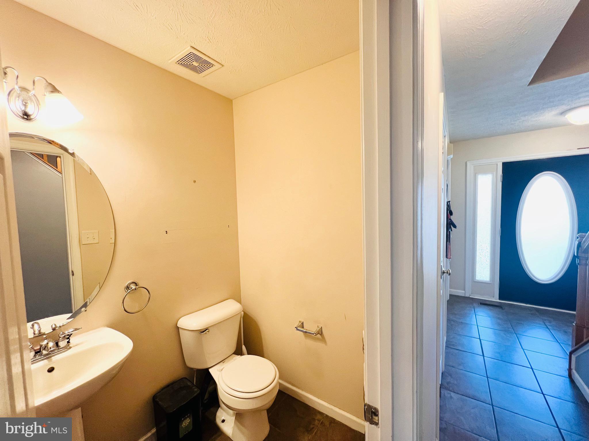 213 Forest Avenue Colonial Beach, VA 22443 - Photo 25 of 54 a bathroom with a toilet sink and mirror