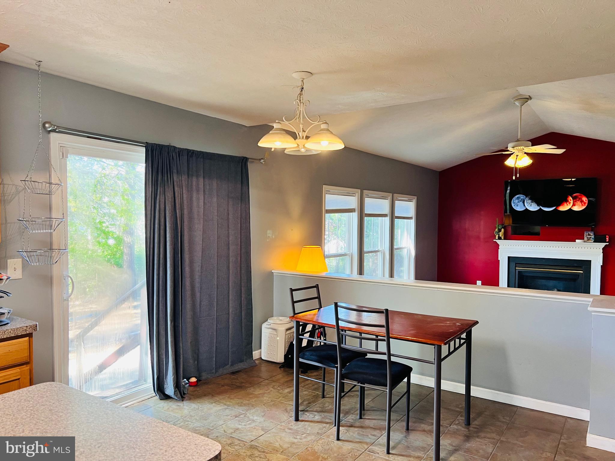 213 Forest Avenue Colonial Beach, VA 22443 - Photo 29 of 54 a room with furniture a chandelier and a window