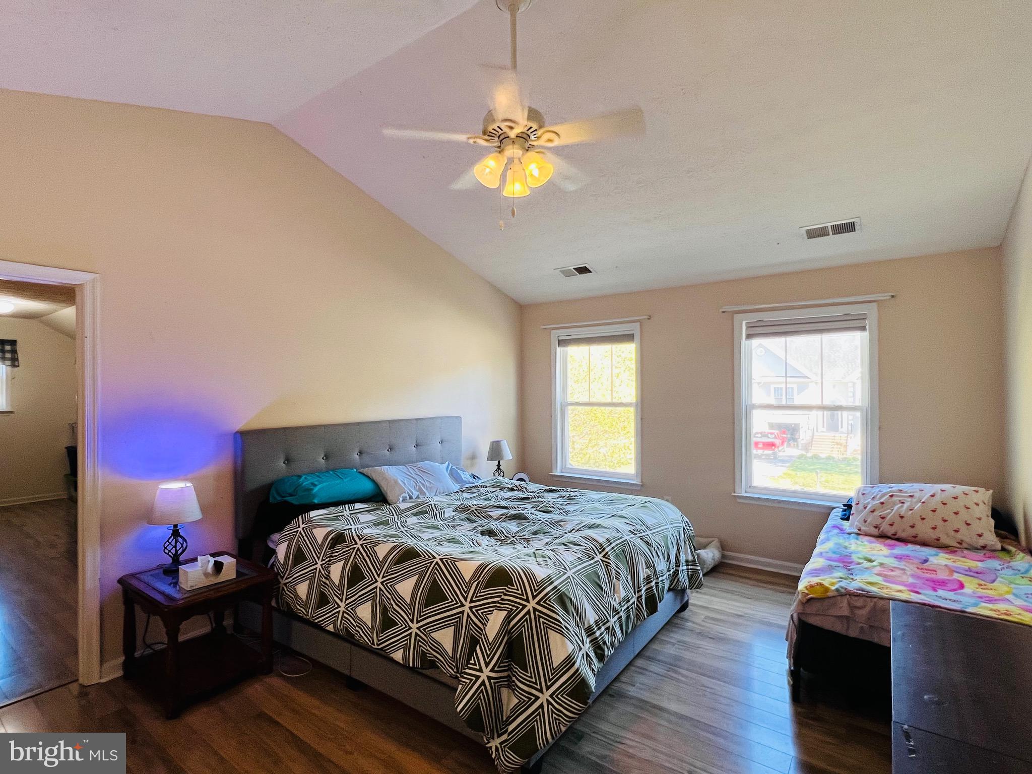213 Forest Avenue Colonial Beach, VA 22443 - Photo 37 of 54 a bedroom with a bed and a chandelier