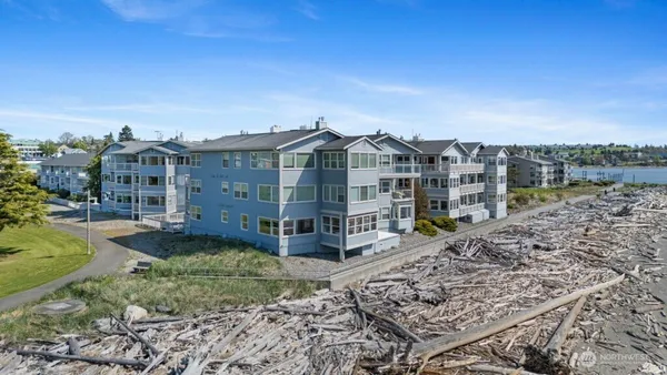 a view of a large house with a yard and large trees