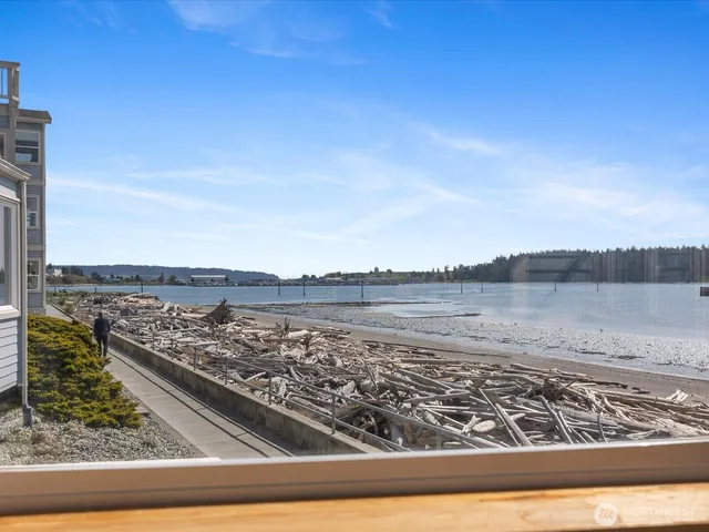 an empty room with cabinet and windows