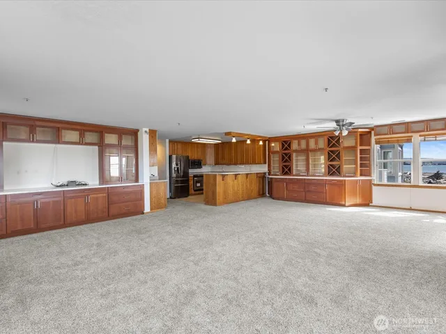 a kitchen with stainless steel appliances granite countertop a sink a stove and a refrigerator