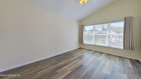 a spacious bathroom with a mirror
