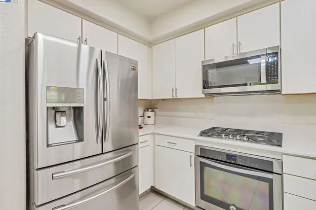 a kitchen with cabinets and stainless steel appliances