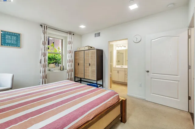 a bedroom with a bed dresser and a window
