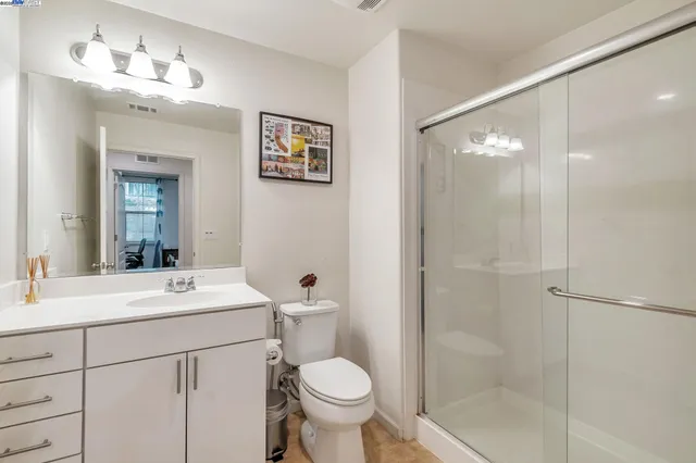 a bathroom with a toilet sink and a mirror