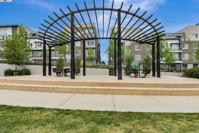 a view of a house with pool and sitting area