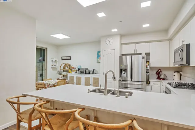 a kitchen with stainless steel appliances granite countertop a sink and cabinets