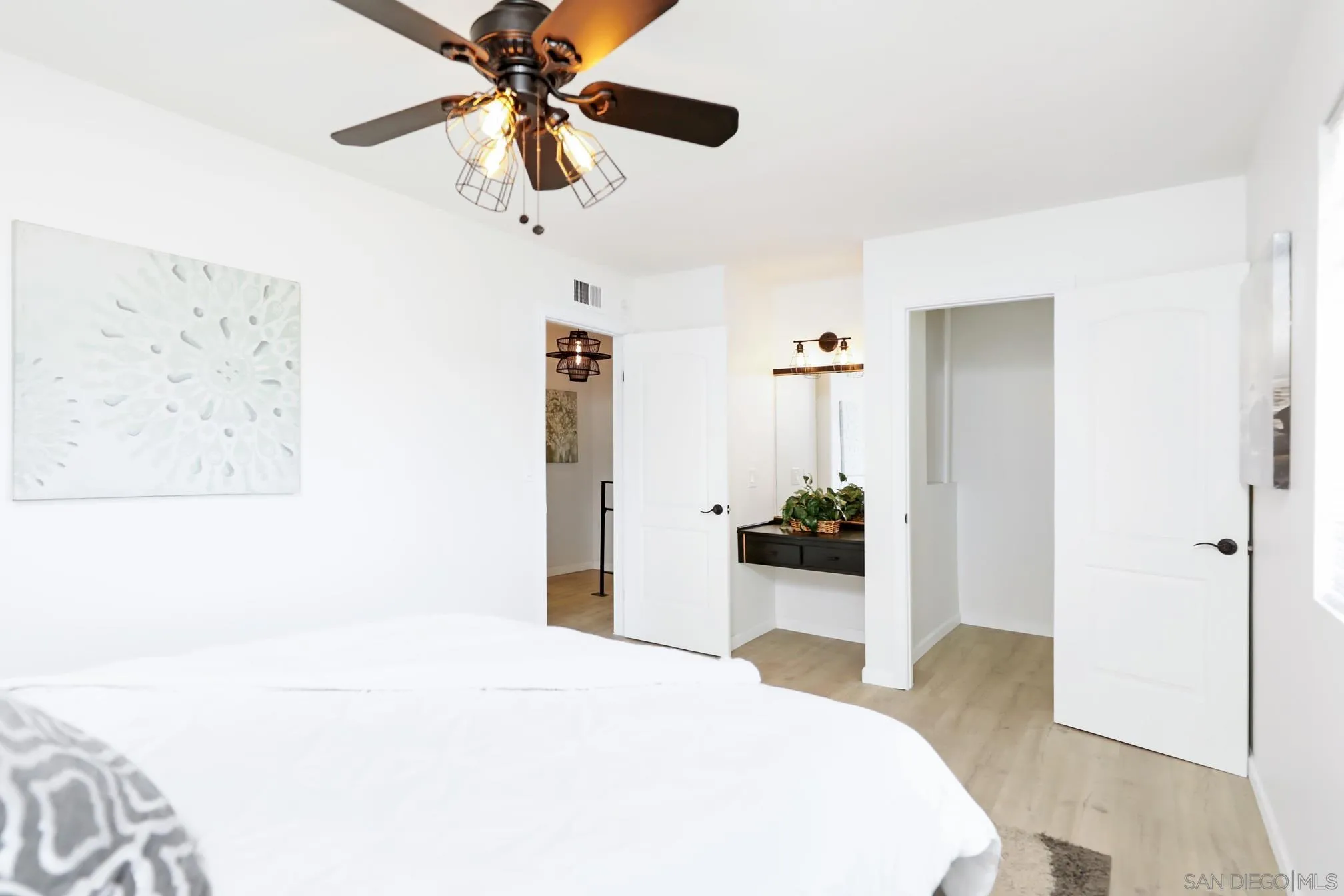 9845 Mission Gorge Road, Unit 3 Santee, CA 92071 - Photo 15 of 25 a bedroom with a bed and a chandelier