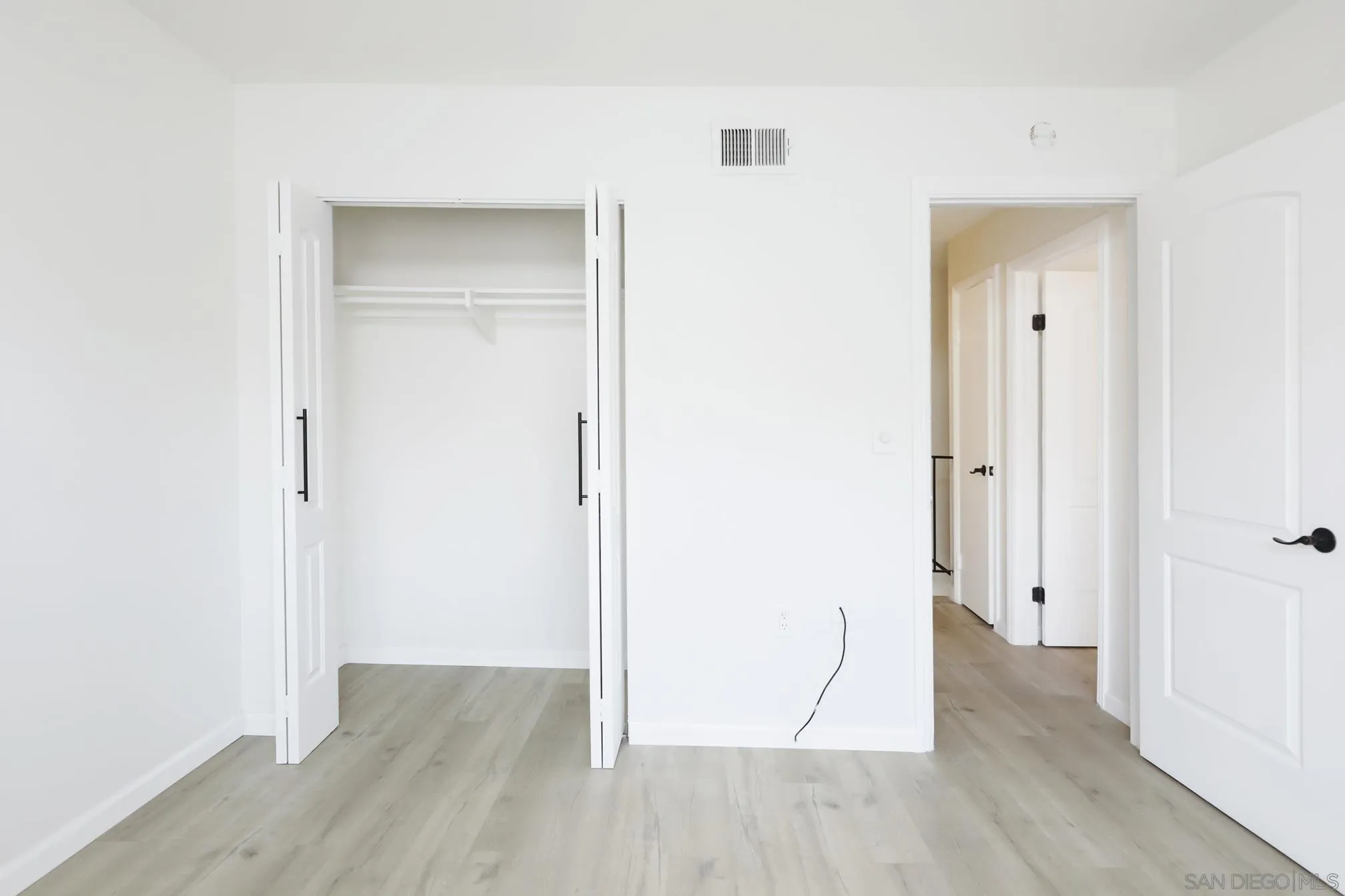 9845 Mission Gorge Road, Unit 3 Santee, CA 92071 - Photo 19 of 25 an empty room with wooden floor & closet area