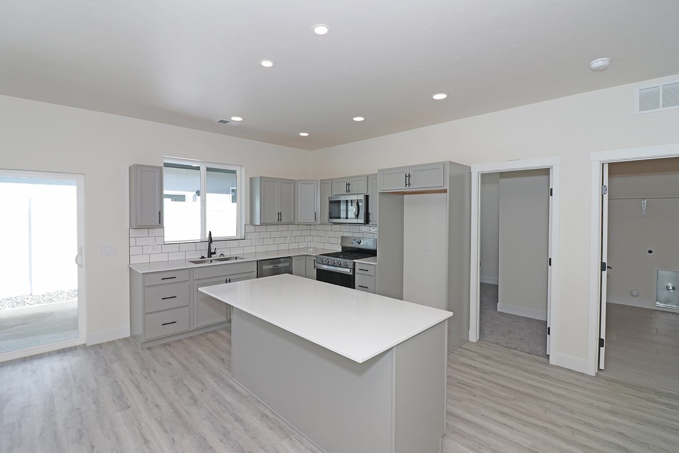 2450 Hamilton Road, Unit B Grand Junction, CO 81505 - Photo 13 of 29 a kitchen with a refrigerator sink and cabinets