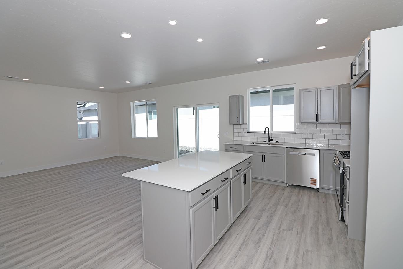 2450 Hamilton Road, Unit B Grand Junction, CO 81505 - Photo 14 of 29 a kitchen with a sink wooden floor and white cabinets