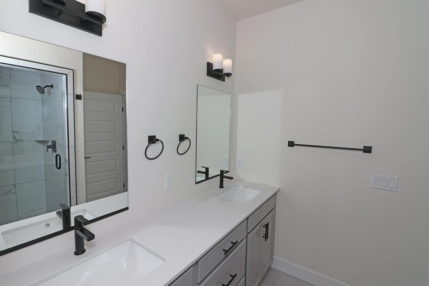 2450 Hamilton Road, Unit B Grand Junction, CO 81505 - Photo 24 of 29 a bathroom with a granite countertop sink a mirror and shower