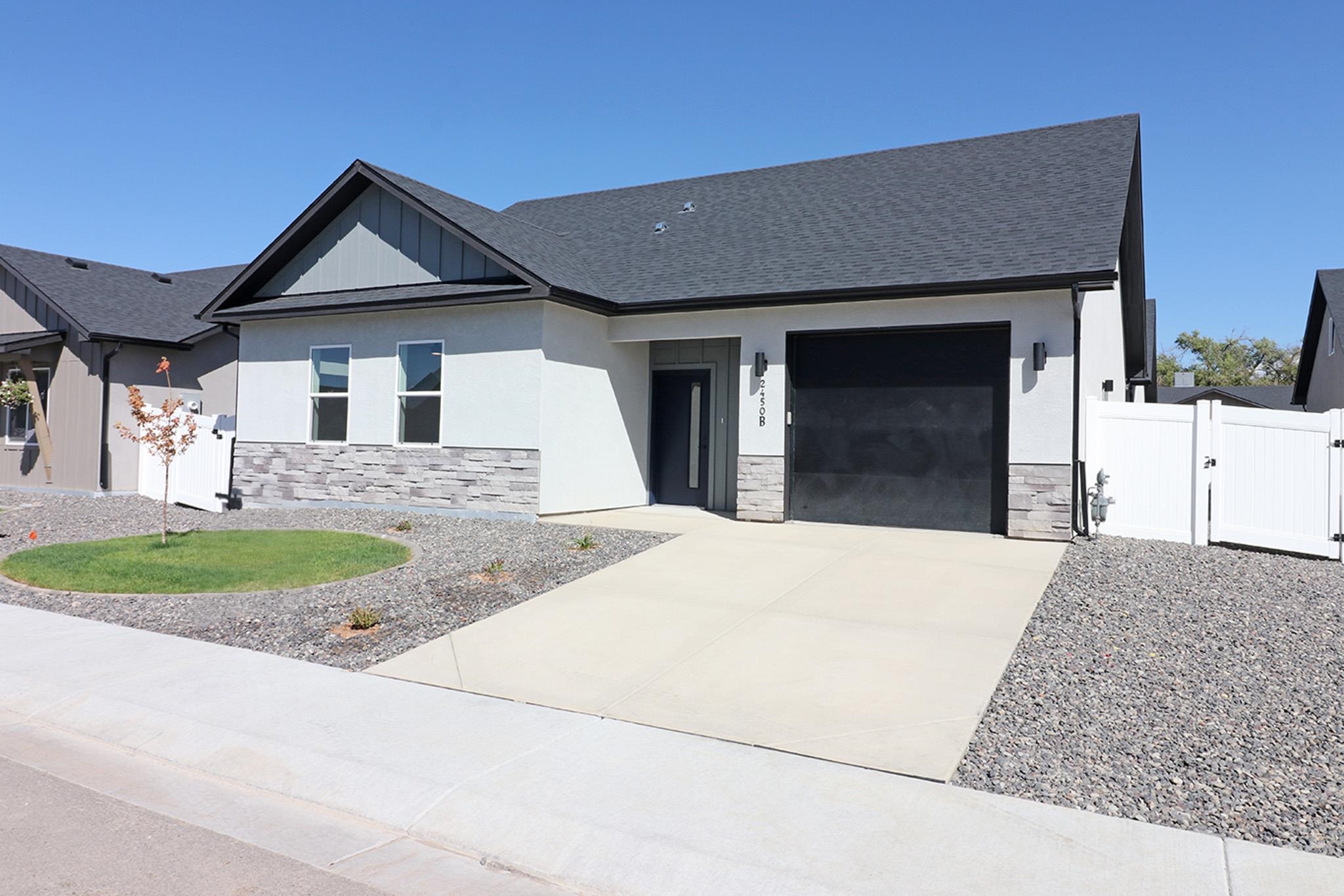 2450 Hamilton Road, Unit B Grand Junction, CO 81505 - Photo 4 of 29 a view of a house with a yard and garage