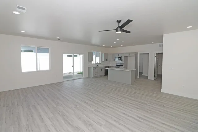 a view of a kitchen with furniture and wooden floor