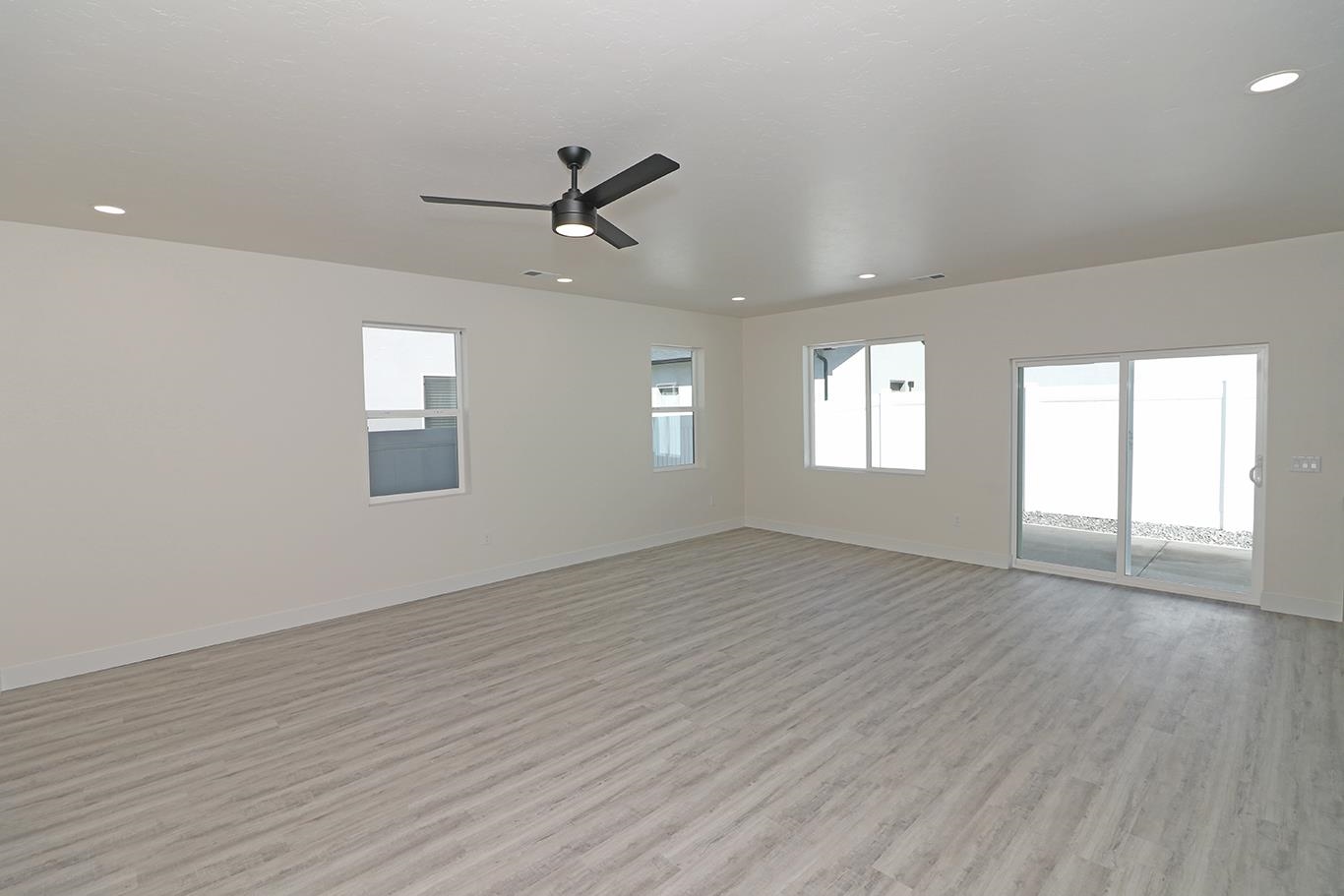 2450 Hamilton Road, Unit B Grand Junction, CO 81505 - Photo 6 of 29 a view of an empty room with a window and wooden floor