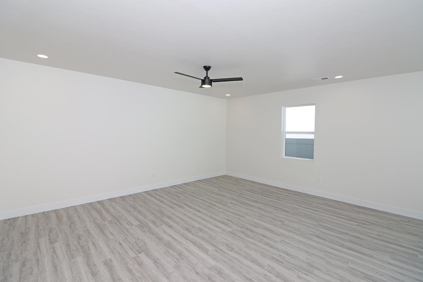 2450 Hamilton Road, Unit B Grand Junction, CO 81505 - Photo 8 of 29 wooden floor in an empty room with a window