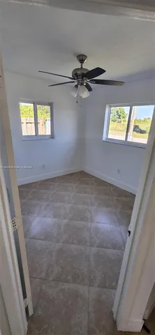 a view of an empty room and a window