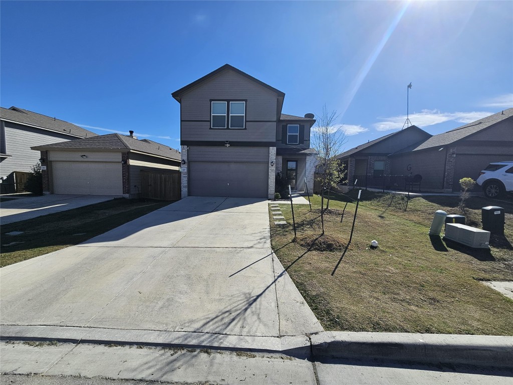 420 Lt. Rusty Jarrell, TX 76537 - Photo 1 of 17 View of front facade featuring a front lawn, concrete driveway, and an attached garage
