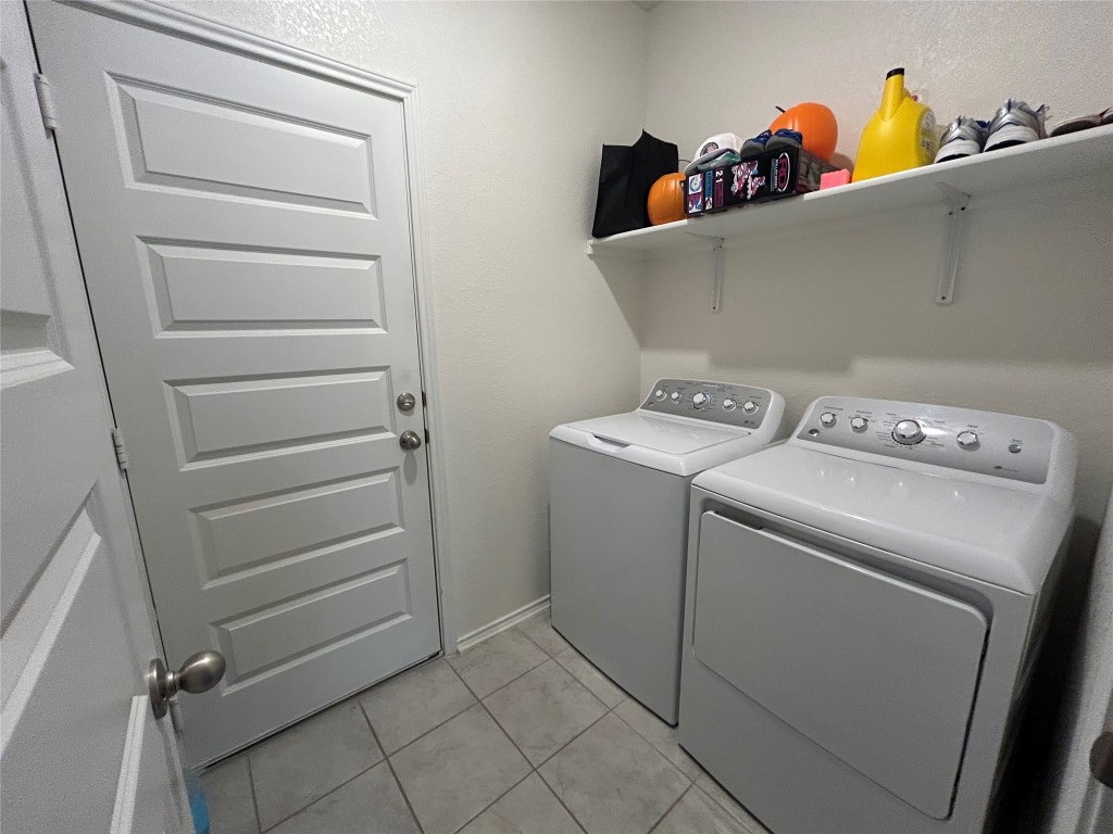 420 Lt. Rusty Jarrell, TX 76537 - Photo 11 of 17 Laundry area with separate washer and dryer, light tile patterned floors, and a textured wall