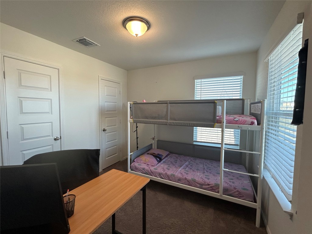 420 Lt. Rusty Jarrell, TX 76537 - Photo 12 of 17 Bedroom with dark colored carpet and a textured ceiling