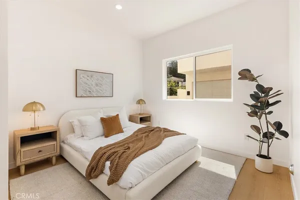 a bedroom with a bed and a lamp