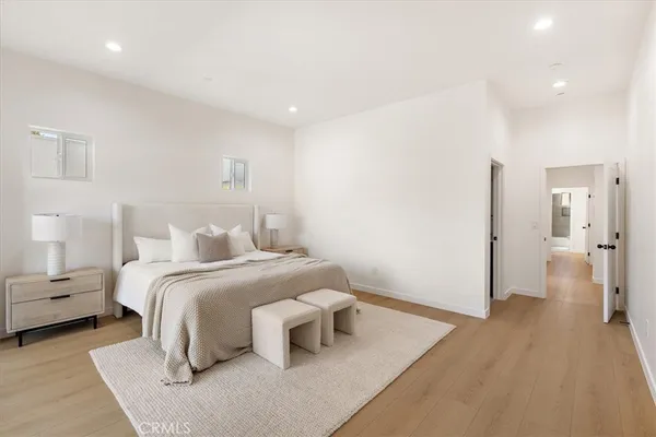 a bedroom with a bed and a large window