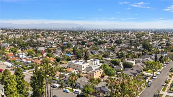 an aerial view of residential houses with city view