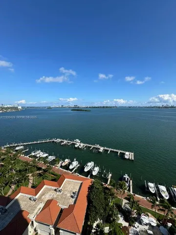an aerial view of a houses with ocean view