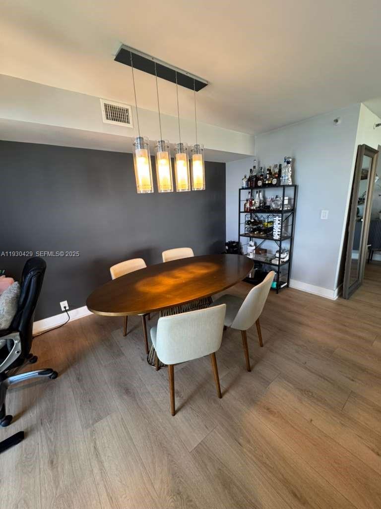 4000 Towerside Terrace, Unit 1901 Miami, FL 33138 - Photo 11 of 33 a room with furniture and a wooden floor