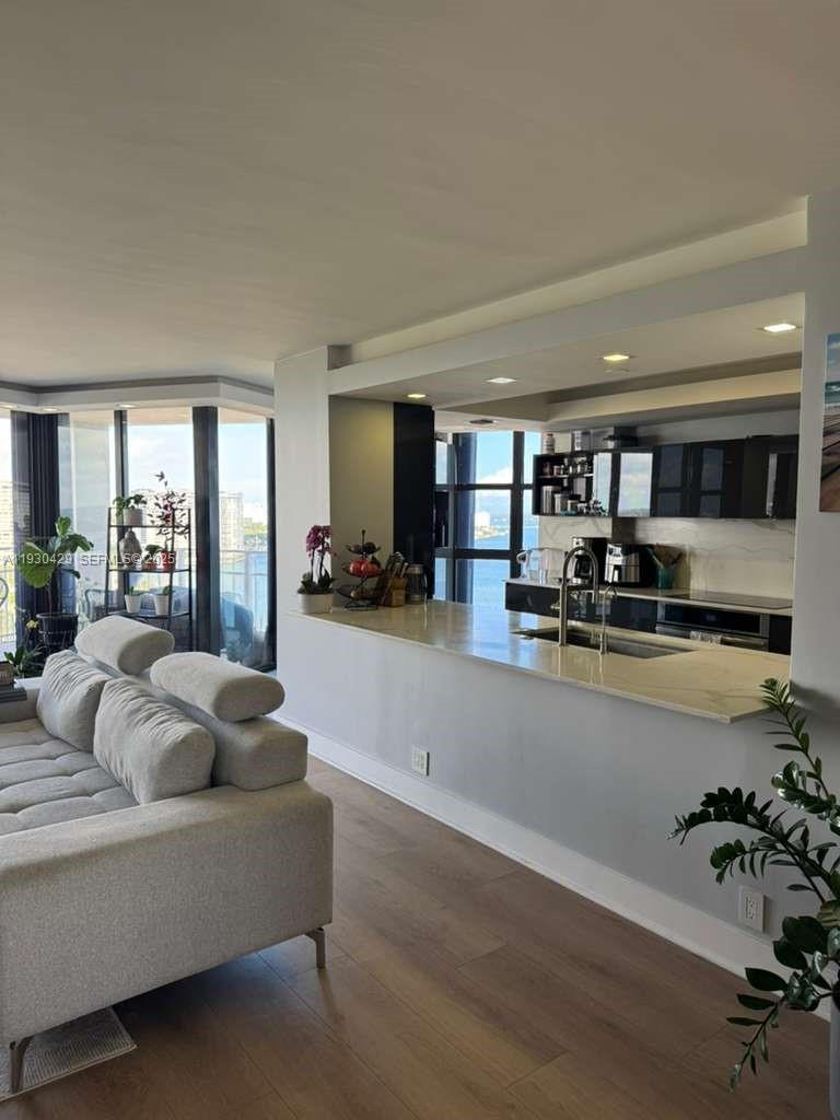 4000 Towerside Terrace, Unit 1901 Miami, FL 33138 - Photo 16 of 33 a living room with furniture and kitchen view