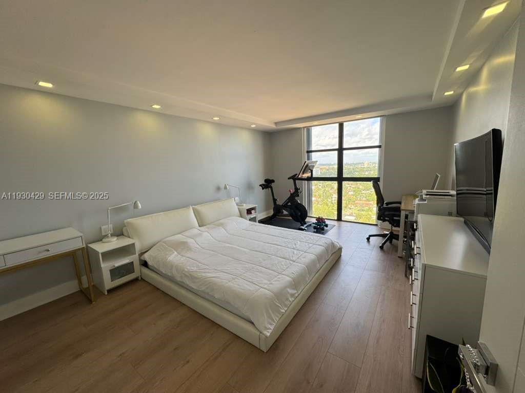 4000 Towerside Terrace, Unit 1901 Miami, FL 33138 - Photo 19 of 33 a bed room with a bed and a chair