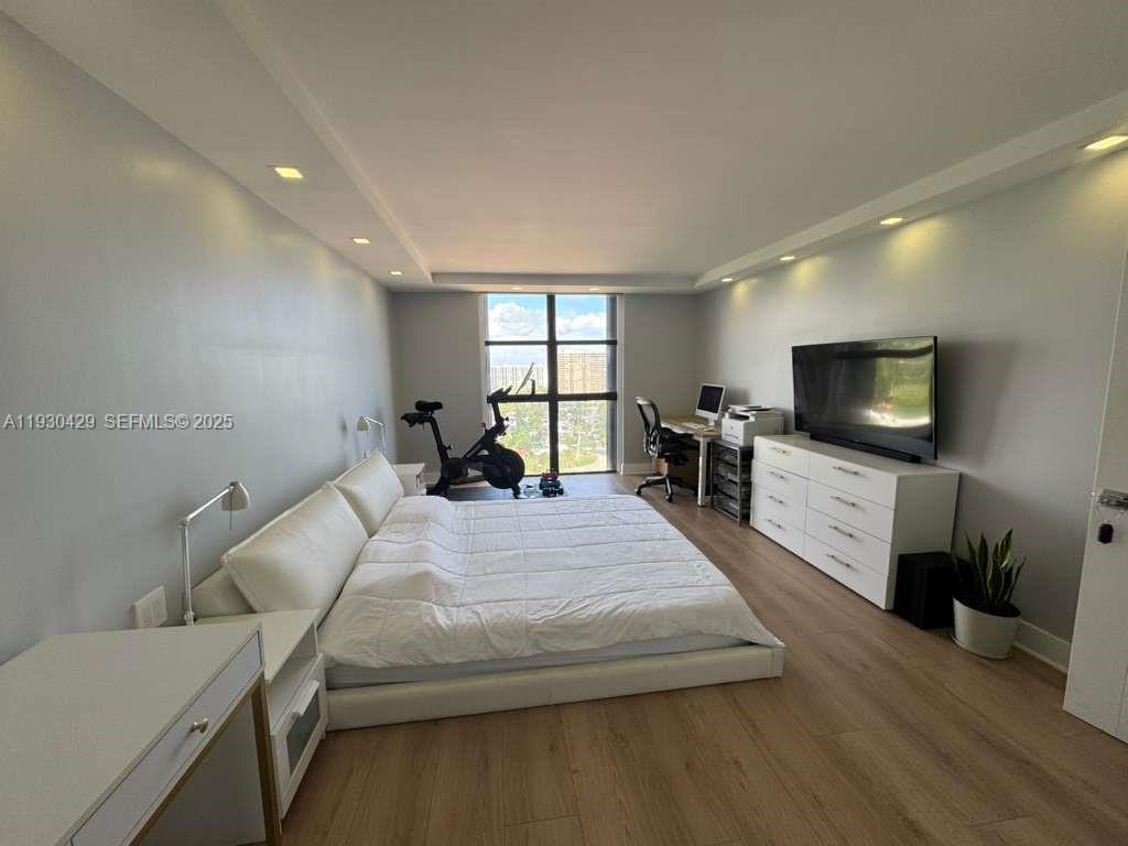 4000 Towerside Terrace, Unit 1901 Miami, FL 33138 - Photo 20 of 33 a bedroom with a bed and a flat screen tv