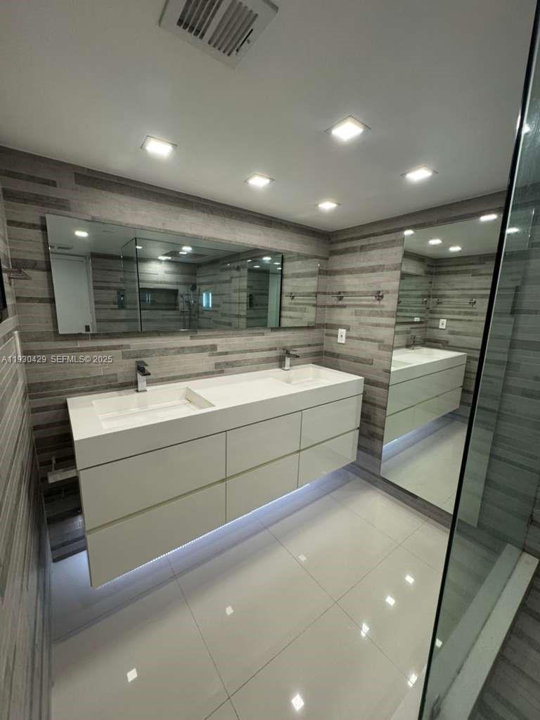 4000 Towerside Terrace, Unit 1901 Miami, FL 33138 - Photo 22 of 33 a bathroom with a sink and a mirror