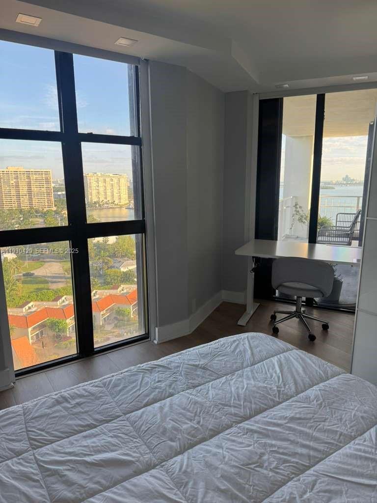 4000 Towerside Terrace, Unit 1901 Miami, FL 33138 - Photo 31 of 33 a bedroom with a bed and large window