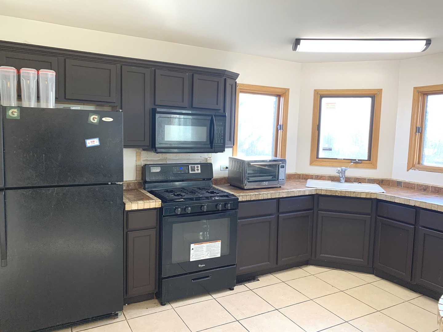 3815 River Road Hazel Crest, IL 60429 - Photo 11 of 25 a kitchen with granite countertop a stove a microwave a sink and a refrigerator