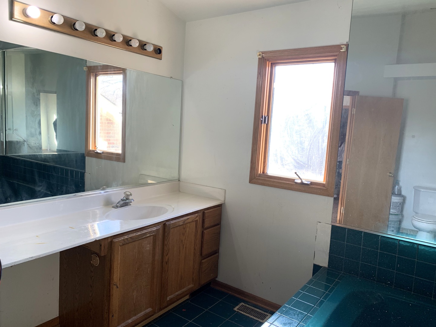 3815 River Road Hazel Crest, IL 60429 - Photo 22 of 25 a bathroom with a sink a mirror and a window