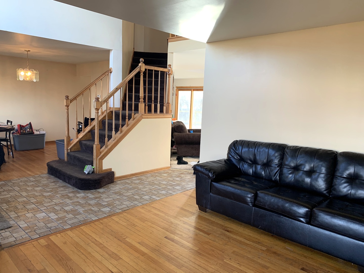 3815 River Road Hazel Crest, IL 60429 - Photo 5 of 25 a living room with couches and a dining table with wooden floor