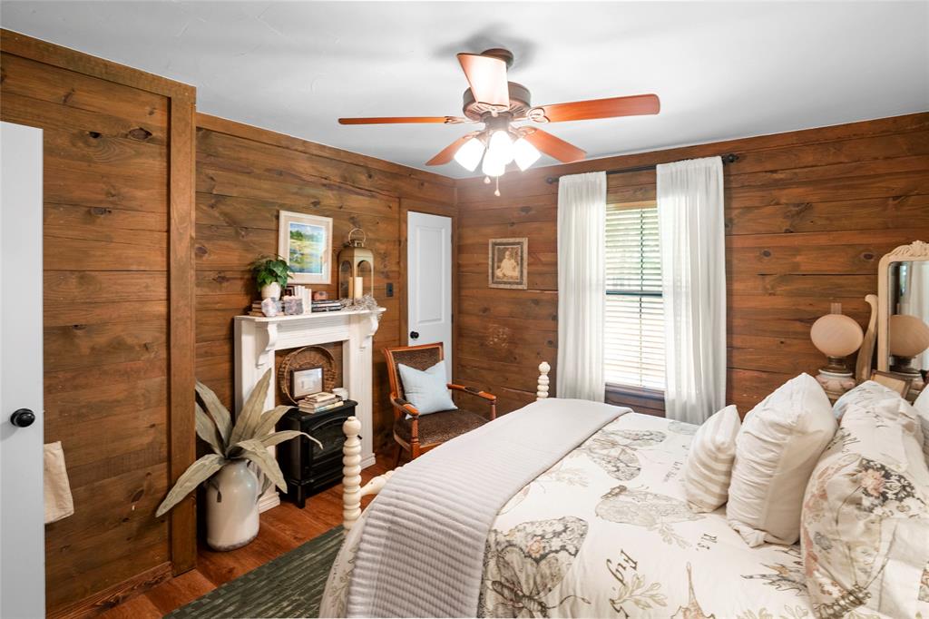 1516 Rancho Road Quinlan, TX 75474 - Photo 23 of 40 a bedroom with a bed and a chandelier