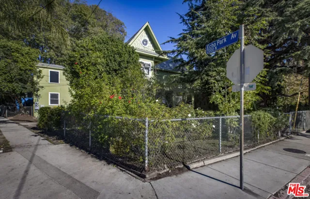 a view of a house with a yard and tree s