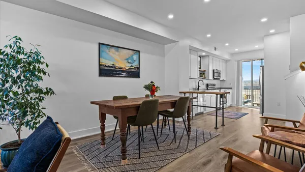 a view of a dining room with furniture window and wooden floor