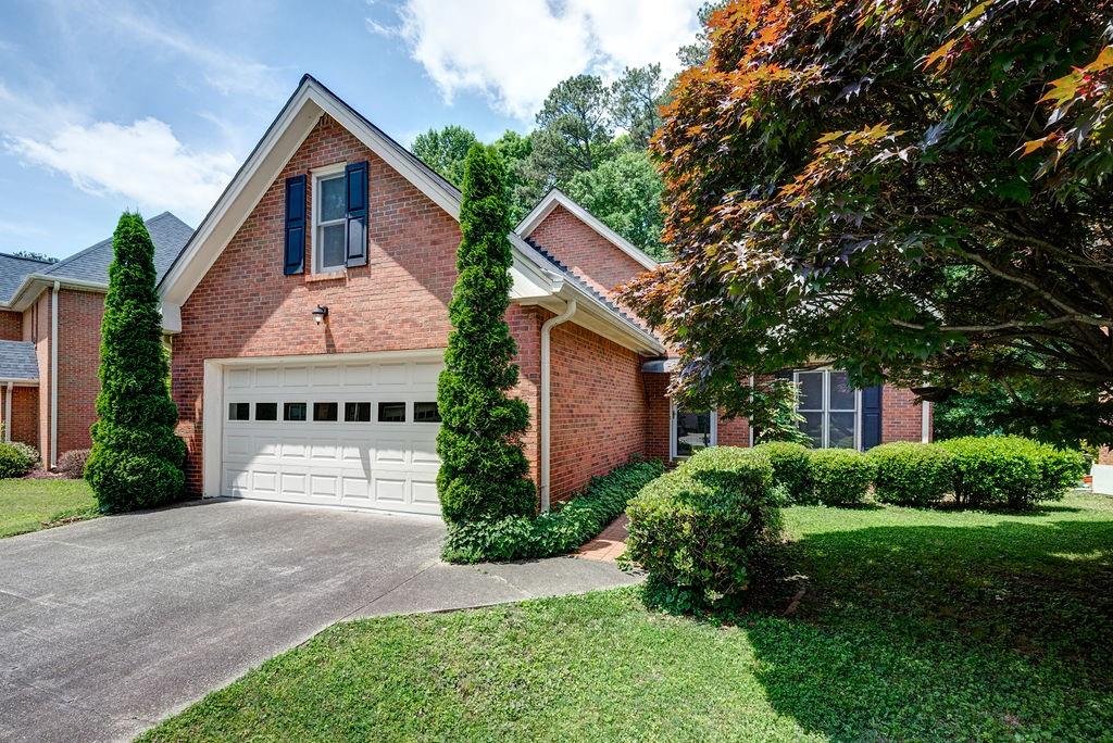 1374 Camden Walk Decatur, GA 30033 - Photo 1 of 1 a front view of a house with a garden and plants