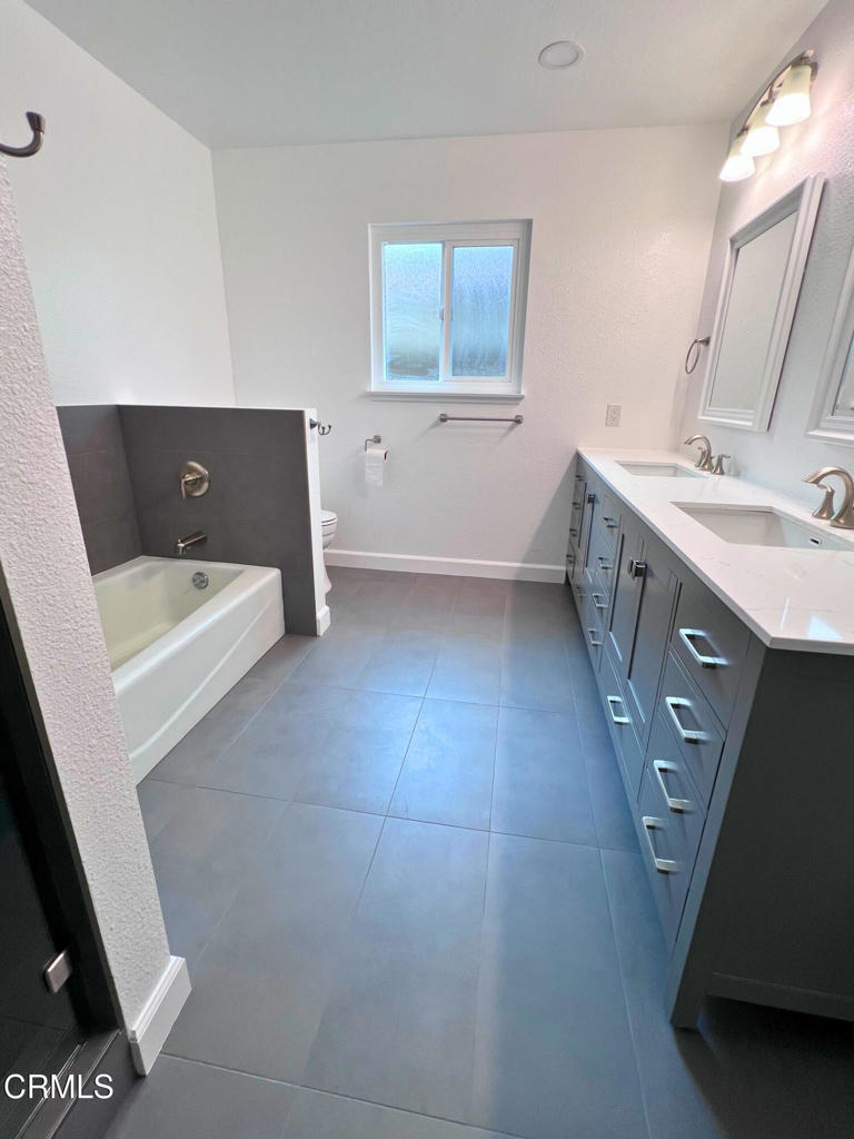 10945 Kings Road Ventura, CA 93004 - Photo 12 of 19 a bathroom with a tub sink and mirror