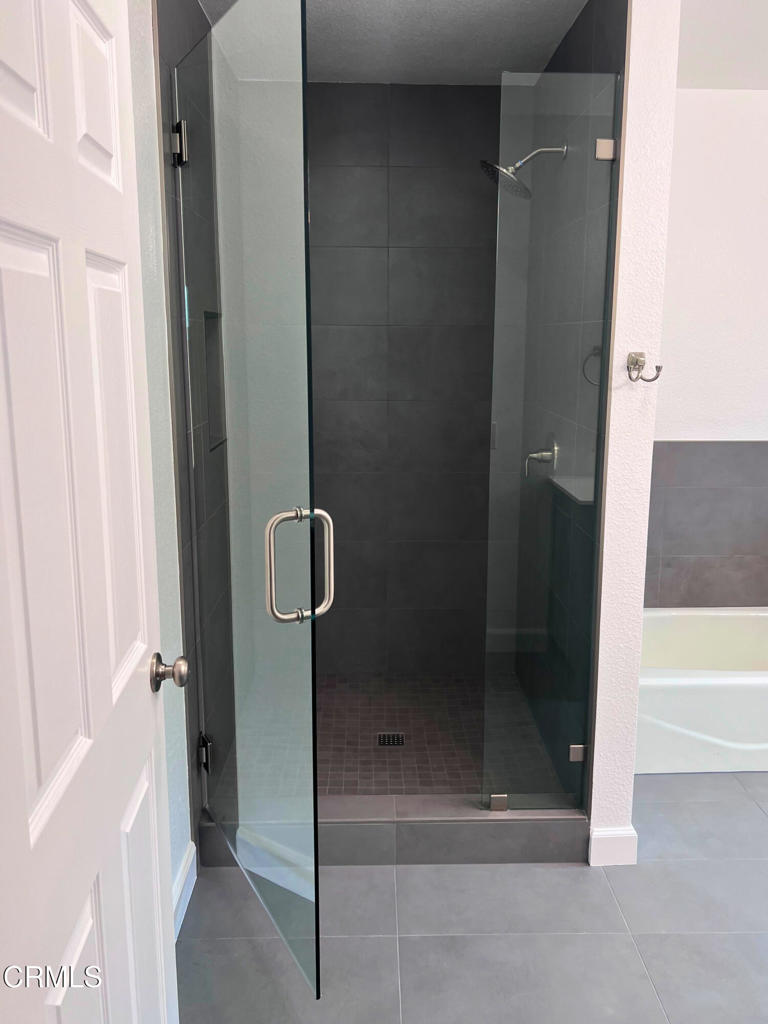 10945 Kings Road Ventura, CA 93004 - Photo 13 of 19 a bathroom with a glass shower door