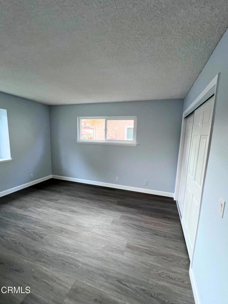 10945 Kings Road Ventura, CA 93004 - Photo 16 of 19 an empty room with wooden floor and window