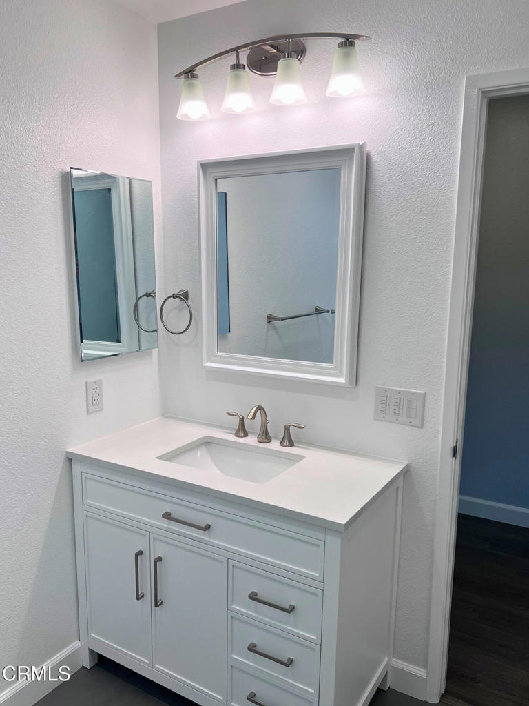 10945 Kings Road Ventura, CA 93004 - Photo 17 of 19 a bathroom with a sink vanity and mirror