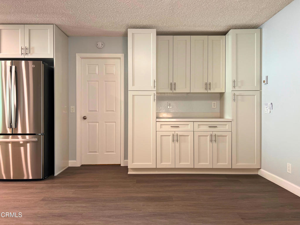 10945 Kings Road Ventura, CA 93004 - Photo 8 of 19 a view of a kitchen with wooden cabinet