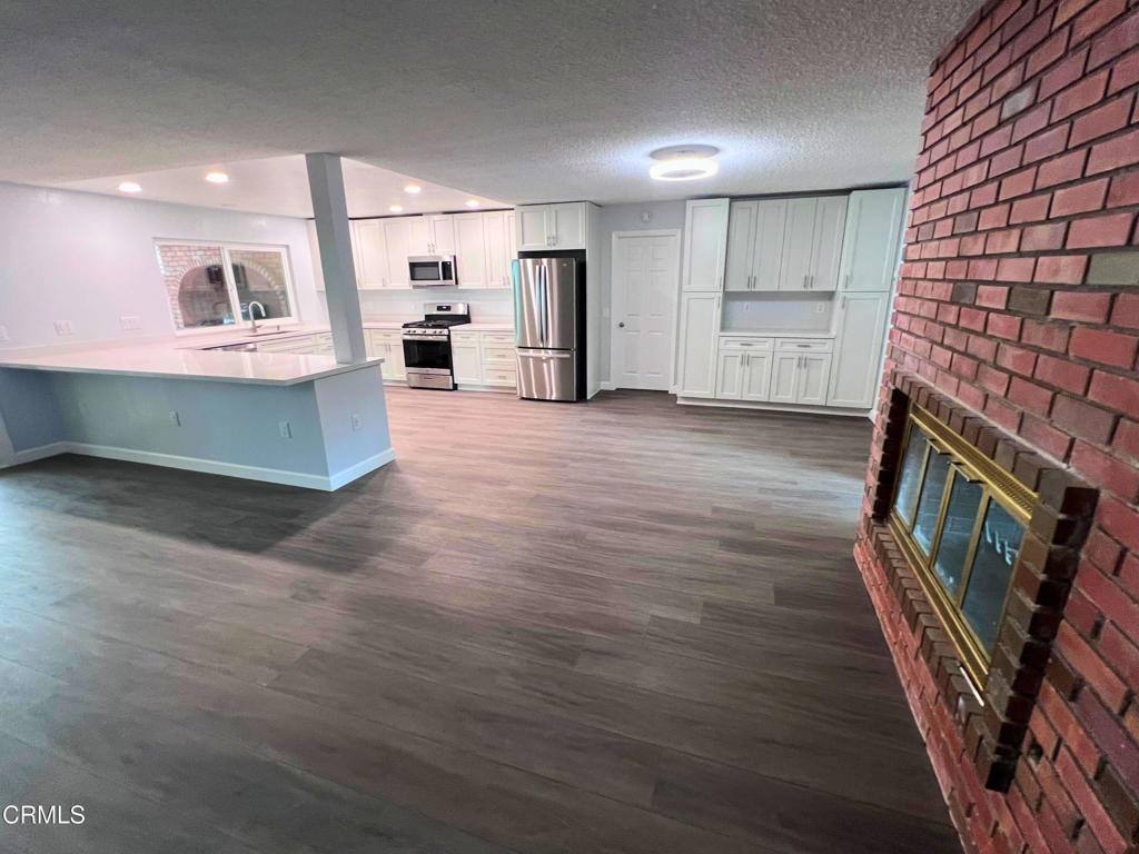10945 Kings Road Ventura, CA 93004 - Photo 9 of 19 a view of kitchen with stainless steel appliances cabinets and wooden floor
