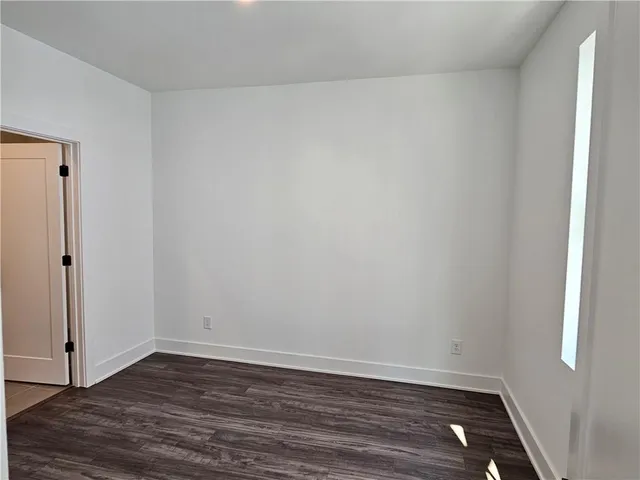 a view of an empty room and wooden floor