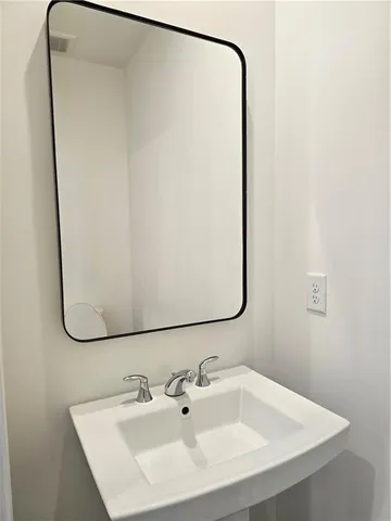 a bathroom with a sink and mirror